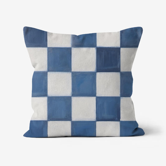 Blue and white checkerboard throw pillow with an impasto-painted texture, featuring a modern geometric pattern on a linen-textured fabric.